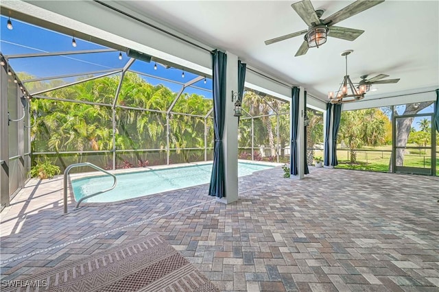 view of pool with ceiling fan, glass enclosure, and a patio area