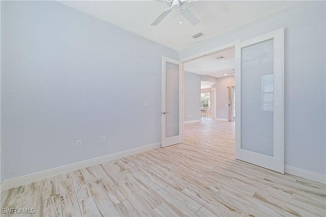 unfurnished room with french doors, light wood-type flooring, and ceiling fan