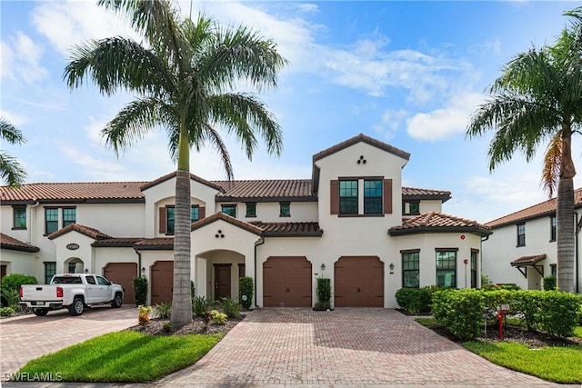 mediterranean / spanish house featuring a garage