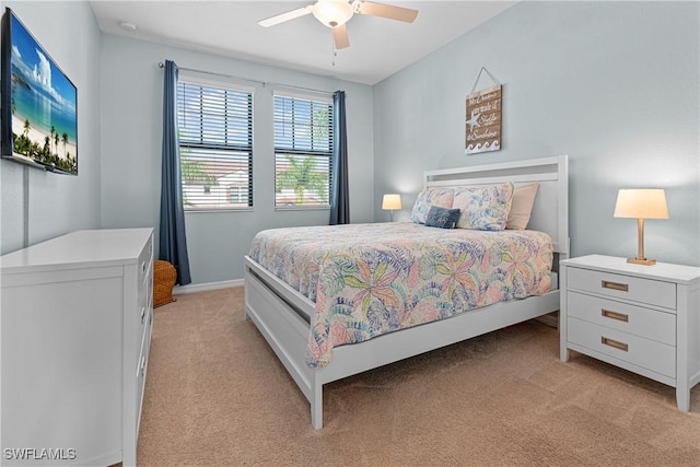 bedroom with ceiling fan and light carpet