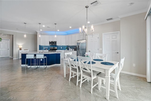 dining area featuring a chandelier and ornamental molding