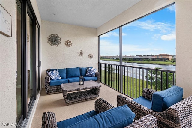 sunroom featuring a water view