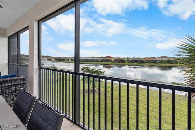 unfurnished sunroom featuring a water view and a wealth of natural light