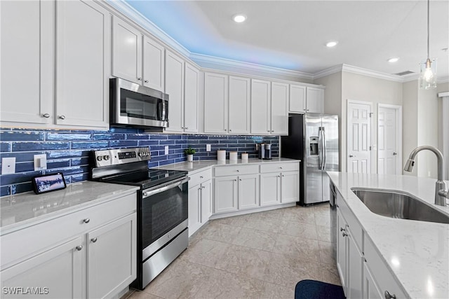 kitchen featuring hanging light fixtures, sink, white cabinets, and stainless steel appliances