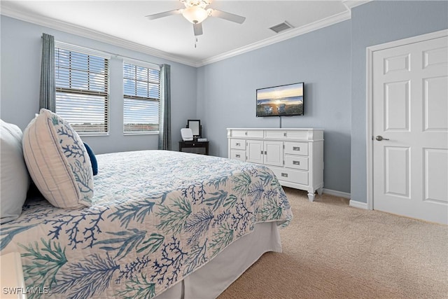 carpeted bedroom with ceiling fan and crown molding