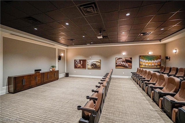 carpeted home theater room with a paneled ceiling