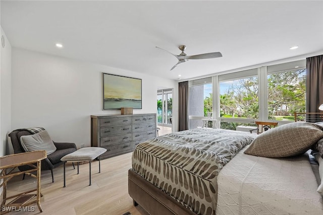 bedroom with multiple windows, ceiling fan, light hardwood / wood-style flooring, and expansive windows