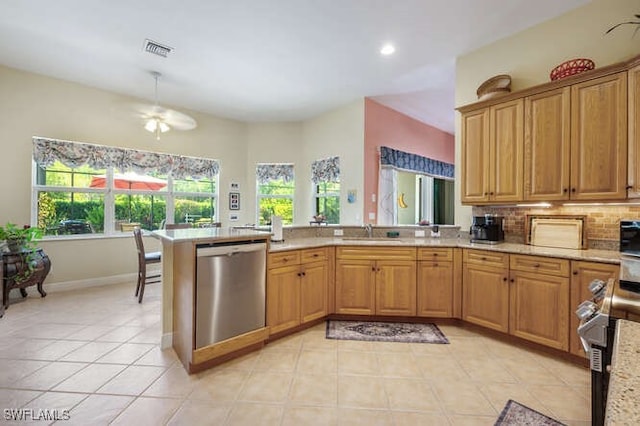 kitchen featuring stainless steel dishwasher, sink, ceiling fan, and light stone counters