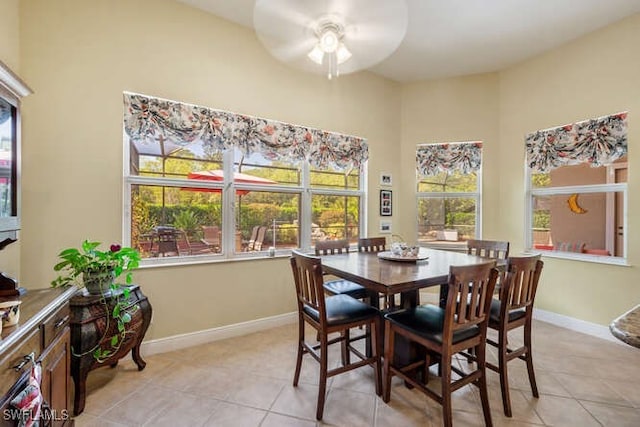 dining space with ceiling fan and light tile patterned floors