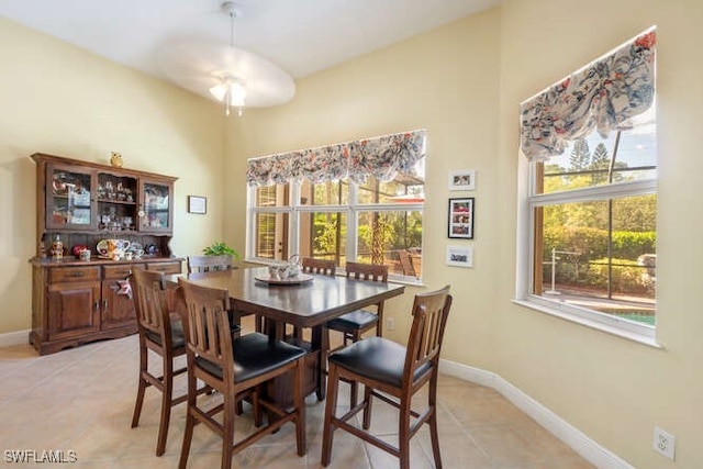 tiled dining space with ceiling fan