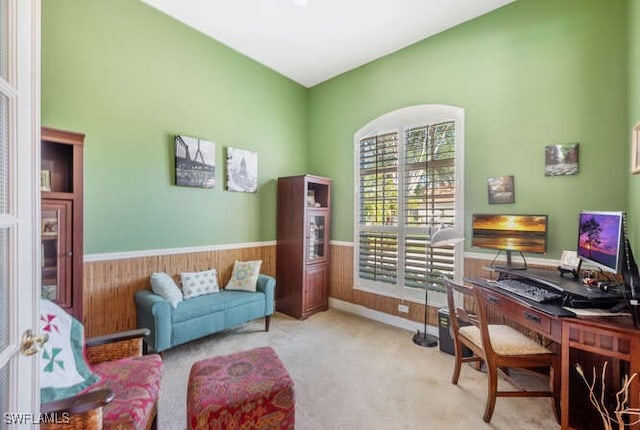 home office featuring light colored carpet and wooden walls