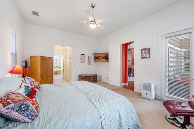 bedroom featuring ensuite bathroom, ceiling fan, and light colored carpet