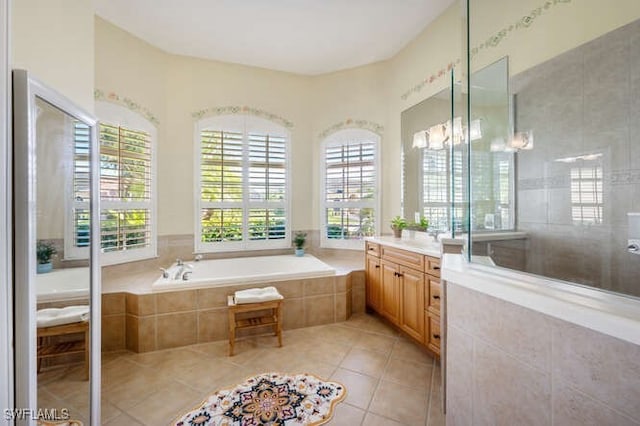 bathroom featuring vanity, tile patterned floors, a notable chandelier, and plus walk in shower