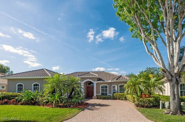 mediterranean / spanish-style house featuring a front lawn