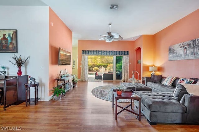 living room with hardwood / wood-style floors and ceiling fan