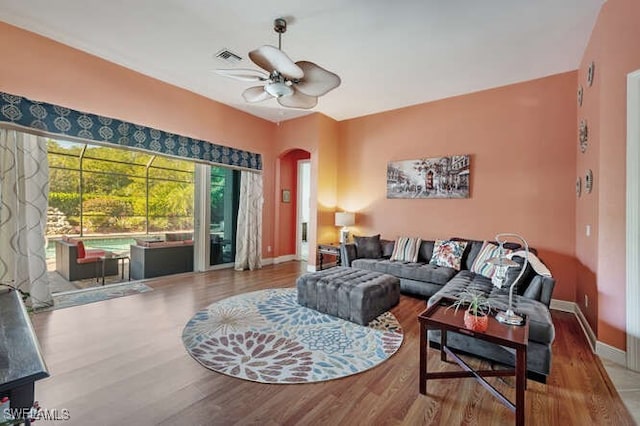 living room with hardwood / wood-style flooring and ceiling fan