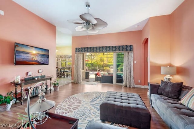 living room featuring ceiling fan and wood-type flooring