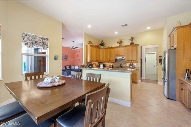 tiled dining area with ceiling fan