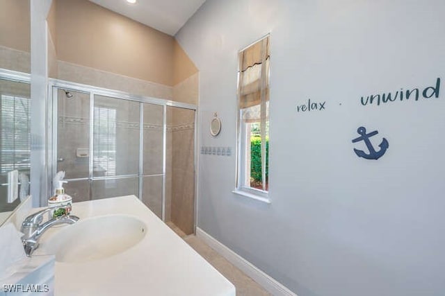 bathroom featuring an enclosed shower and vanity