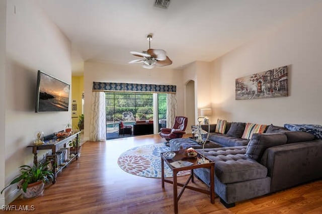 living room featuring ceiling fan and wood-type flooring