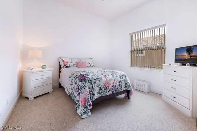 bedroom featuring light carpet