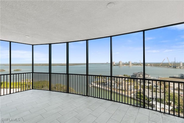 unfurnished sunroom with a water view