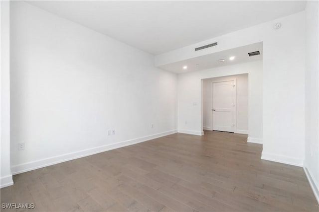 spare room featuring wood-type flooring