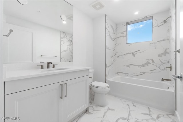 full bathroom with toilet, vanity, and tiled shower / bath