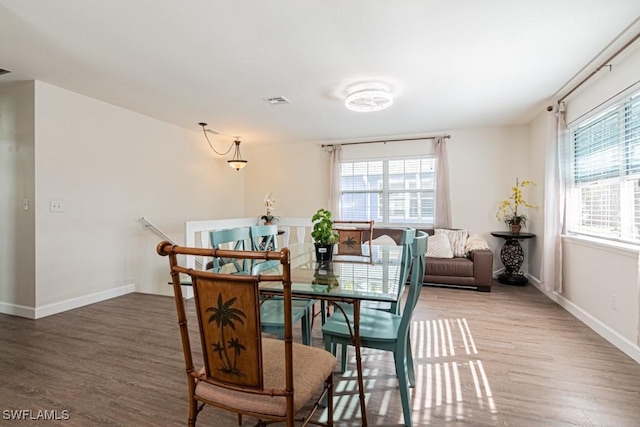 dining space featuring wood-type flooring