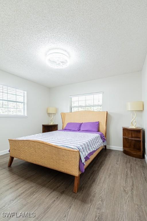 bedroom featuring hardwood / wood-style flooring and a textured ceiling