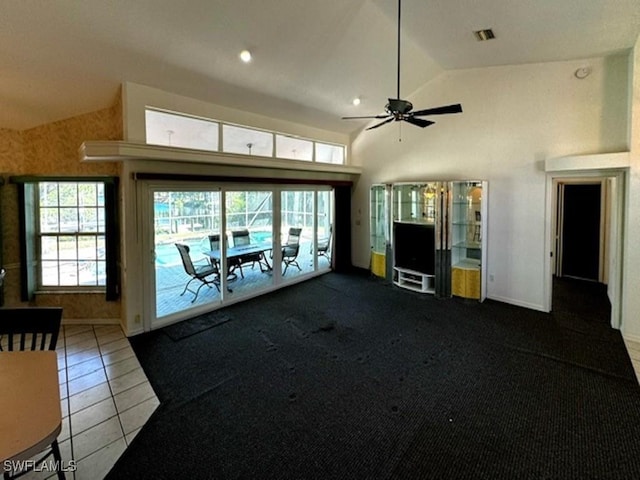 unfurnished living room with tile patterned floors, ceiling fan, and vaulted ceiling