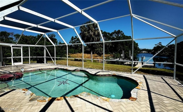 view of swimming pool featuring a lanai and a patio