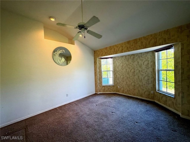 empty room with carpet, a healthy amount of sunlight, ceiling fan, and lofted ceiling