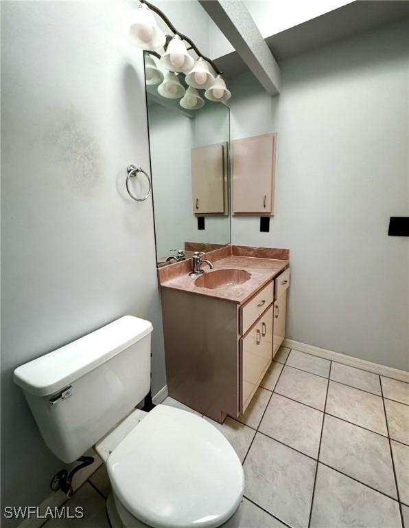 bathroom with tile patterned floors, vanity, and toilet