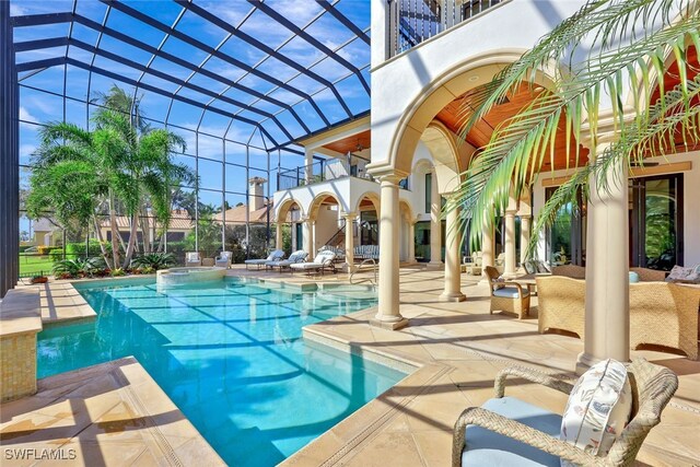 view of pool featuring a patio area and a lanai