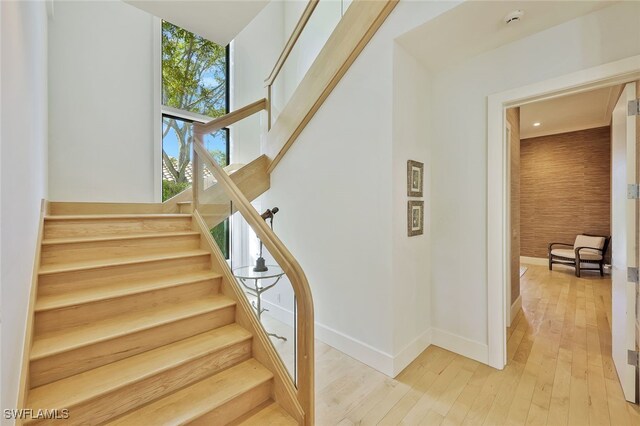 stairway with hardwood / wood-style flooring