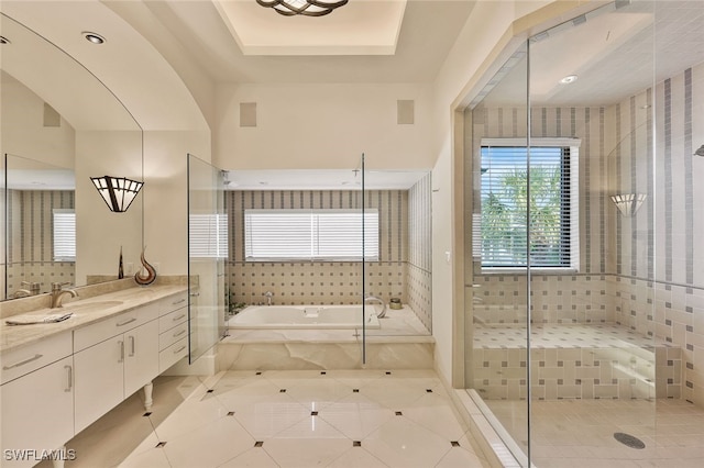 bathroom featuring shower with separate bathtub, vanity, and tile patterned floors