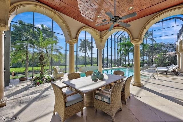 sunroom / solarium with ceiling fan and wood ceiling