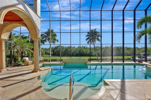 view of swimming pool featuring glass enclosure