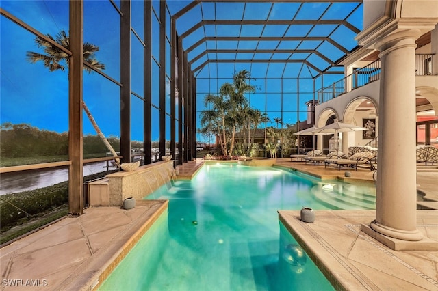 view of swimming pool with glass enclosure, an outdoor living space, and a patio