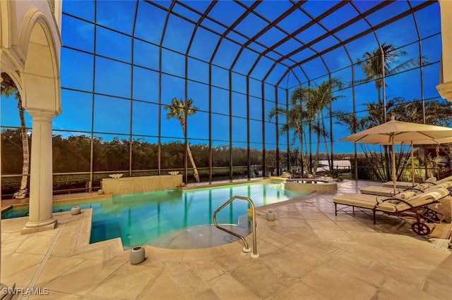 view of pool featuring glass enclosure and a patio