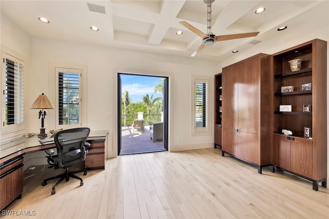 home office with beam ceiling, light wood-type flooring, a wealth of natural light, and coffered ceiling