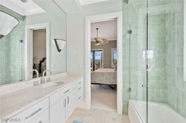 bathroom with tile patterned flooring, ceiling fan, bath / shower combo with glass door, and vanity