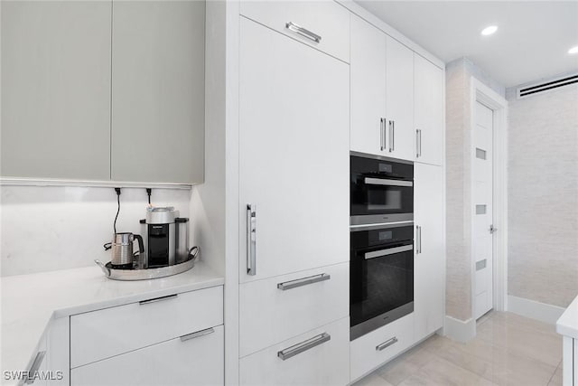 kitchen featuring black double oven and white cabinetry