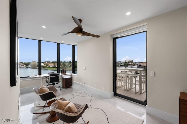 office space with ceiling fan, a water view, and light tile patterned floors