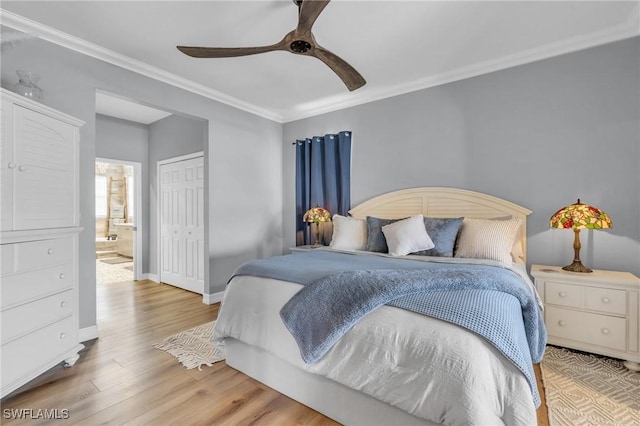 bedroom featuring baseboards, a closet, light wood-style flooring, and crown molding