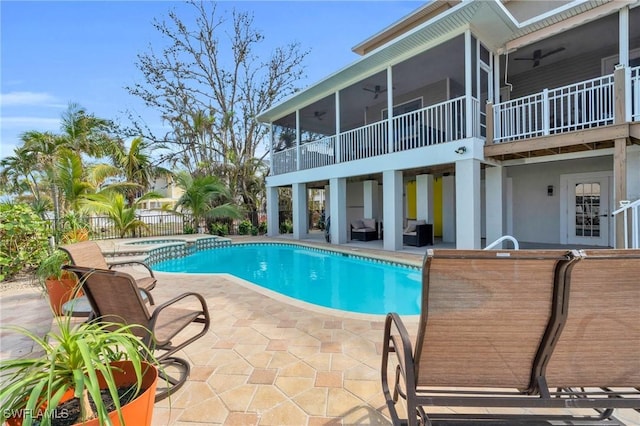 view of pool featuring a fenced in pool, a sunroom, outdoor dry bar, an in ground hot tub, and a patio area