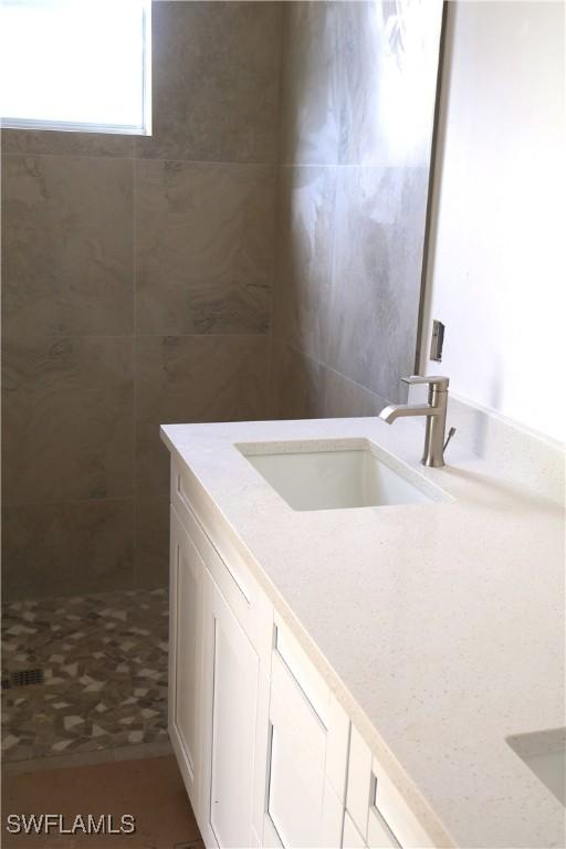 bathroom featuring vanity and walk in shower