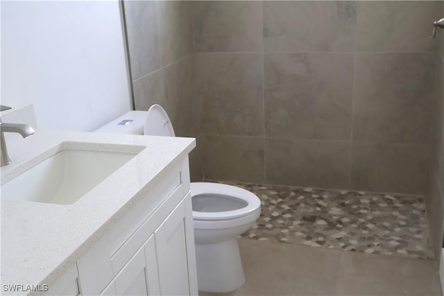 bathroom with a shower, vanity, and toilet