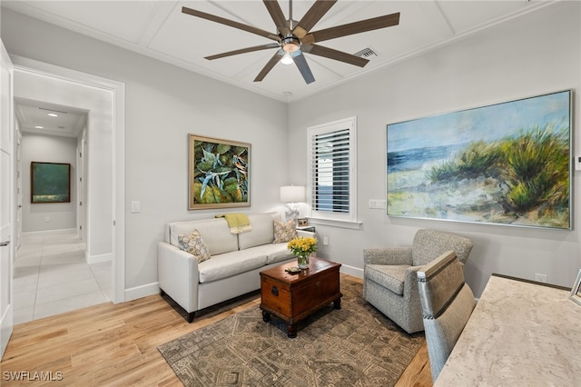 living room with crown molding, light hardwood / wood-style floors, and ceiling fan